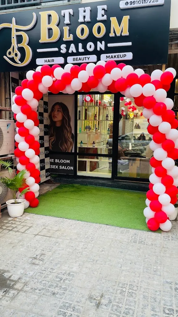 The Bloom Salon's storefront sign in Sushant Lok, with balloon decorations across the entrance and a glimpse of the styling area through the glass front.